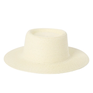 Close-up of the intricate weave and texture of the cream flat-top wide-brim straw hat