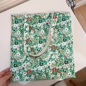 Close-up of vibrant green floral print on double-layered large capacity canvas tote bag