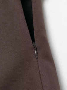 Detailed macro view of dark brown fabric texture and high-quality invisible zipper