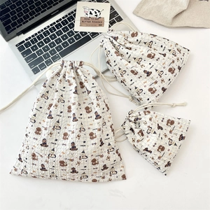 Three sizes of embossed seersucker drawstring bags with cartoon puppy pattern detail
