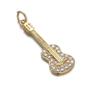 Detailed close-up of a golden guitar-shaped pendant inlaid with sparkling clear zircons