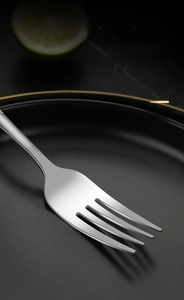 Detail of high-quality gold-plated stainless steel fork with a polished mirror finish