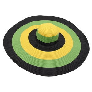 Oversized wide brim straw hat with bold yellow green and black stripes for beach sun protection