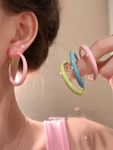 Detailed close-up of colorful enamel hoops in pink, light blue, and lime green finishes