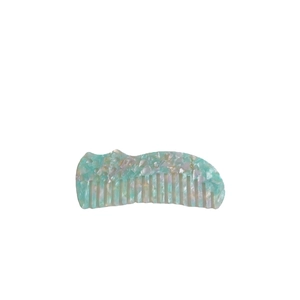 Cute green acetate hair comb with marble pattern and shell texture on white background