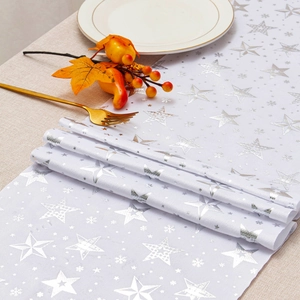 Detail of white velvet table runner with silver star and snowflake foil printing