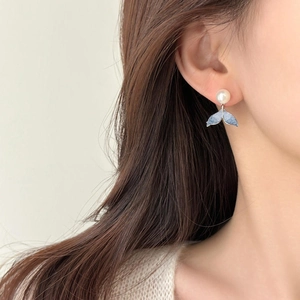 Elegant silver pearl earrings with blue gradient fish tail drop on a female model