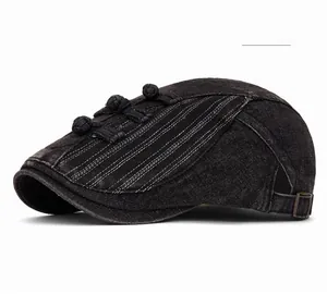 Detail of dark grey denim beret featuring traditional Chinese frog buttons and metal buckle