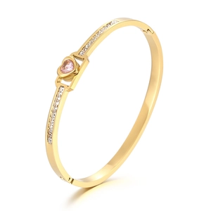 Gold-plated stainless steel open bangle with pink heart stone and side diamond accents