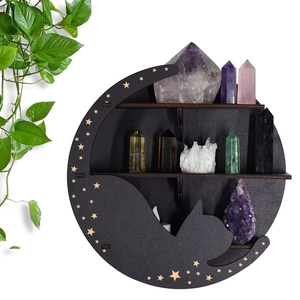 Detailed view of 3-tier black wooden moon cat shelf holding crystals and candles