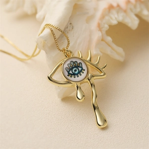 Retro gold evil eye teardrop pendant necklace on shell background for women