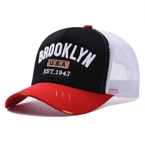 Close-up of BROOKLYN embroidery on vintage mesh trucker hat with red distressed brim