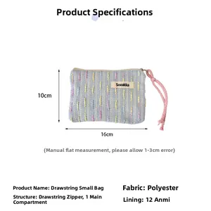 Detailed view of light blue woven cosmetic bag with pink zipper cord and size dimensions
