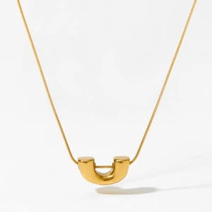 Minimalist gold U-shaped pendant necklace with a polished finish on a delicate snake chain