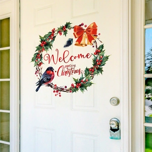 Detail of watercolor Christmas wreath sticker with bells and berries on a white door