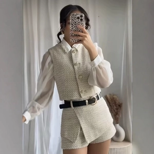 Women's chic beige tweed vest and shorts set with pearl buttons and black waist belt