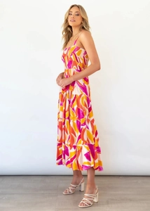 Macro detail of the tiered hem and vibrant abstract floral print on the midi sundress