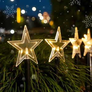 Solar powered star shaped LED garden stake lights with warm white glow for Christmas decor