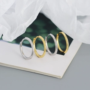 Macro shot of polished gold and silver S925 sterling silver hoop earrings set