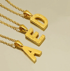 Detailed view of 18K gold-plated stainless steel necklaces with A, E, and D letter pendants