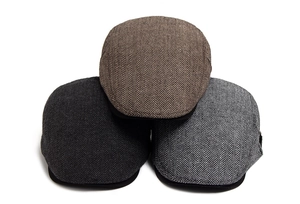 Three men's retro herringbone flat caps in brown, dark grey and light grey wool texture