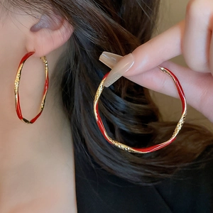 Fashionable large gold hoop earrings with irregular red enamel wave design for women