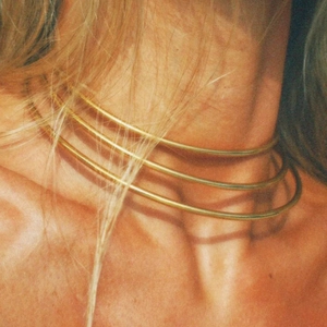 Close-up of triple-layered 14K gold-plated stainless steel choker in vintage film style