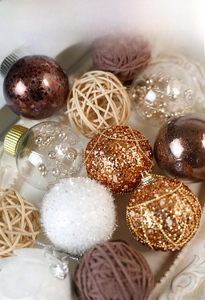 Close-up of white and gold Christmas ball ornaments with sequins and plush details