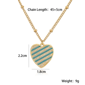 Detail of 18K gold-plated heart pendant with blue enamel and sparkling rhinestones