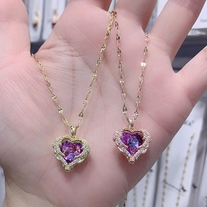 Vergoldete Herzkette mit lila Kristallanhänger und schimmernden kleinen Diamanten