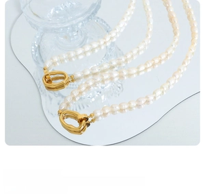 Detailed macro view of high-quality freshwater pearls with a golden organic OT toggle clasp