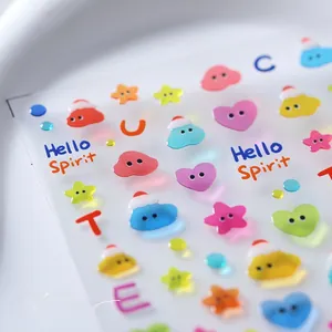 Macro detail of 3D embossed nail art stickers with cute cloud and star relief patterns