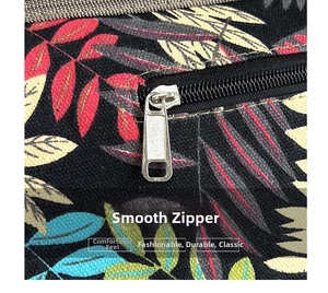 Close-up of smooth metal zipper and tropical leaf print on the fabric tote bag