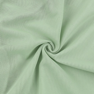 Detailed macro view of breathable mint green mesh fabric showing soft texture and transparency