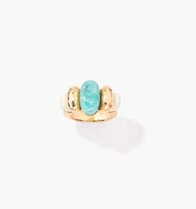 Detail of oval turquoise stone on ring with gold hammered texture and metallic finish