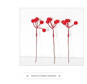 Close-up of bright red artificial Christmas berries with glossy finish and realistic texture