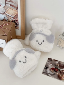 Close-up of plush white flip gloves with cute embroidered smiley faces and heart accents