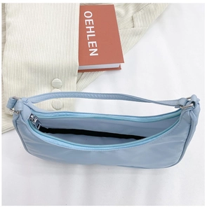 Detailed top view of light blue nylon crescent bag showing interior space and silver zipper