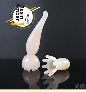 Detailed view of resin amber massage tools with octopus claw design for face and scalp