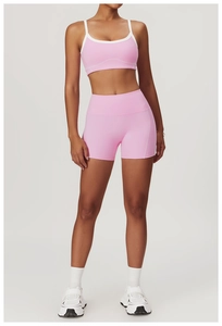 Detailed full-body view of pink yoga set with contrast piping and high-waist shorts