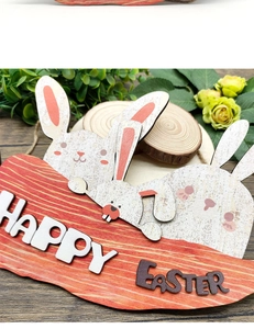 Detail of wooden Happy Easter sign with cute rabbit figurines on a rustic wood surface