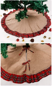 Close-up of linen Christmas tree skirt with red plaid ruffles and ribbon tie closure