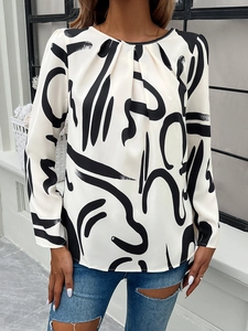 Detail of white long sleeve shirt with black abstract print and pleated crew neckline