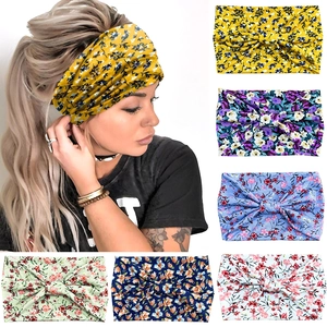 Detail view of wide elastic headbands in six floral patterns and twisted knot design
