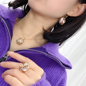 Golden wire-wrapped baroque pearl jewelry set including necklace, earrings, and ring