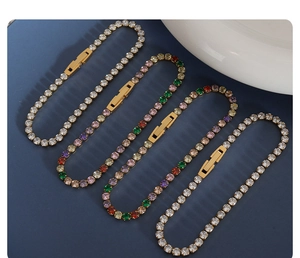 Detailed close-up of four gold plated tennis bracelets with white and colorful cubic zirconia