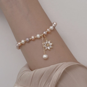 Elegant freshwater pearl bracelet with zircon sunflower pendant and gold floral charm