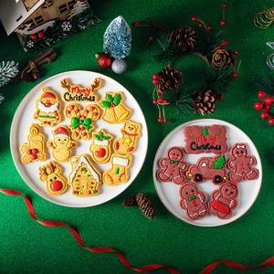 Christmas cookie molds set with ginger man and reindeer shapes on festive green background