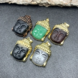 Set of five crystal glass Buddha head pendants with gold and copper plated metal edges