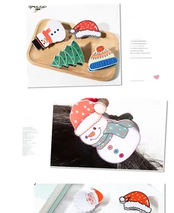 Detailed view of Christmas themed hair clips with snowman, tree and Santa Claus designs